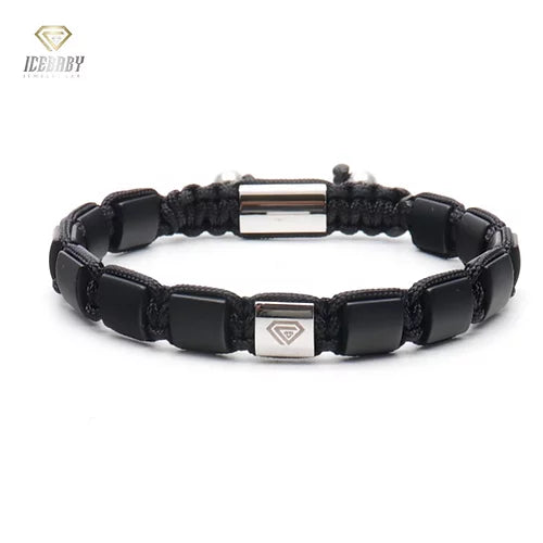 BRACELET  WITH BLACK ONYX AND GOLD CHARM.